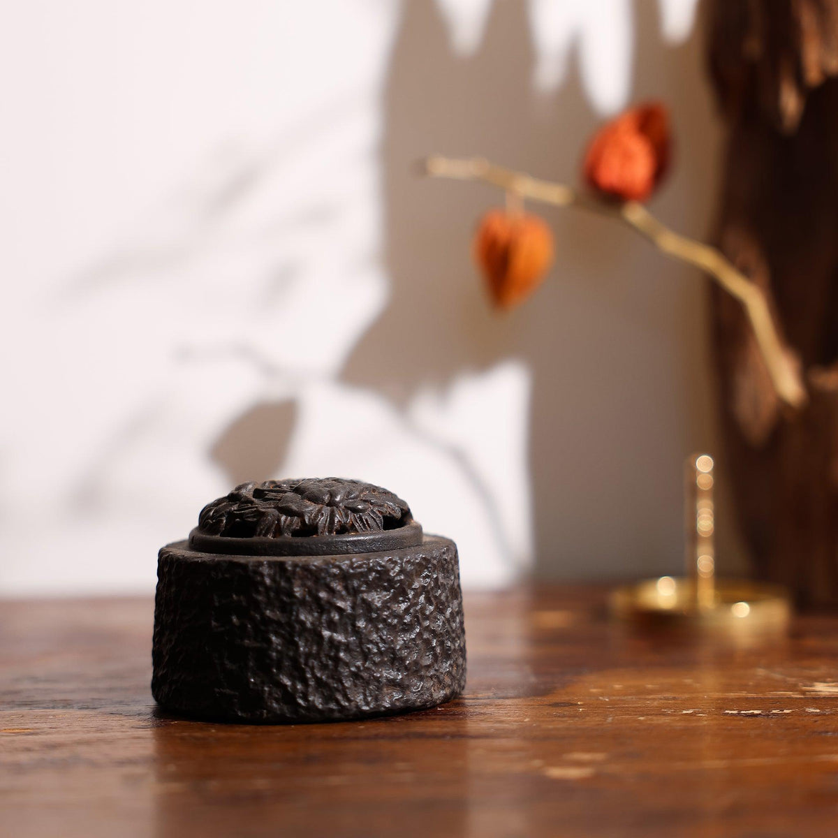 Side view of incense powder burner by Kin Objects on a table