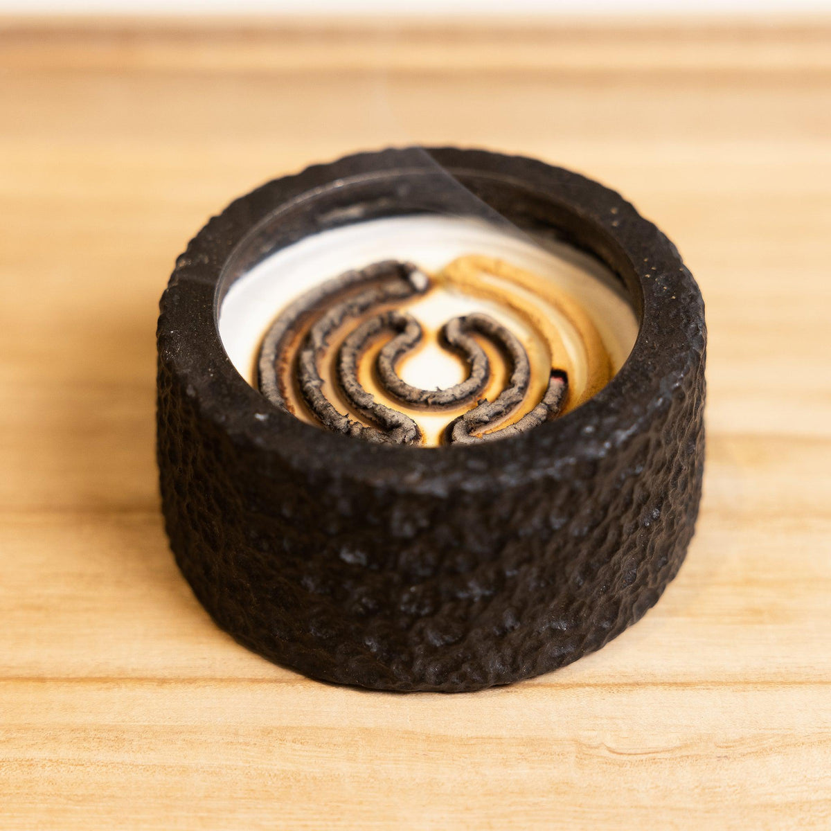 Half burnt view of an incense seal or incense trail