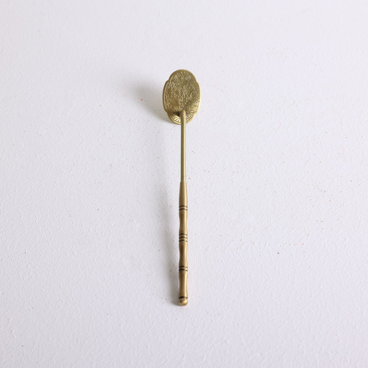 A bronze ash press for flatting white ash for burning incense powder
