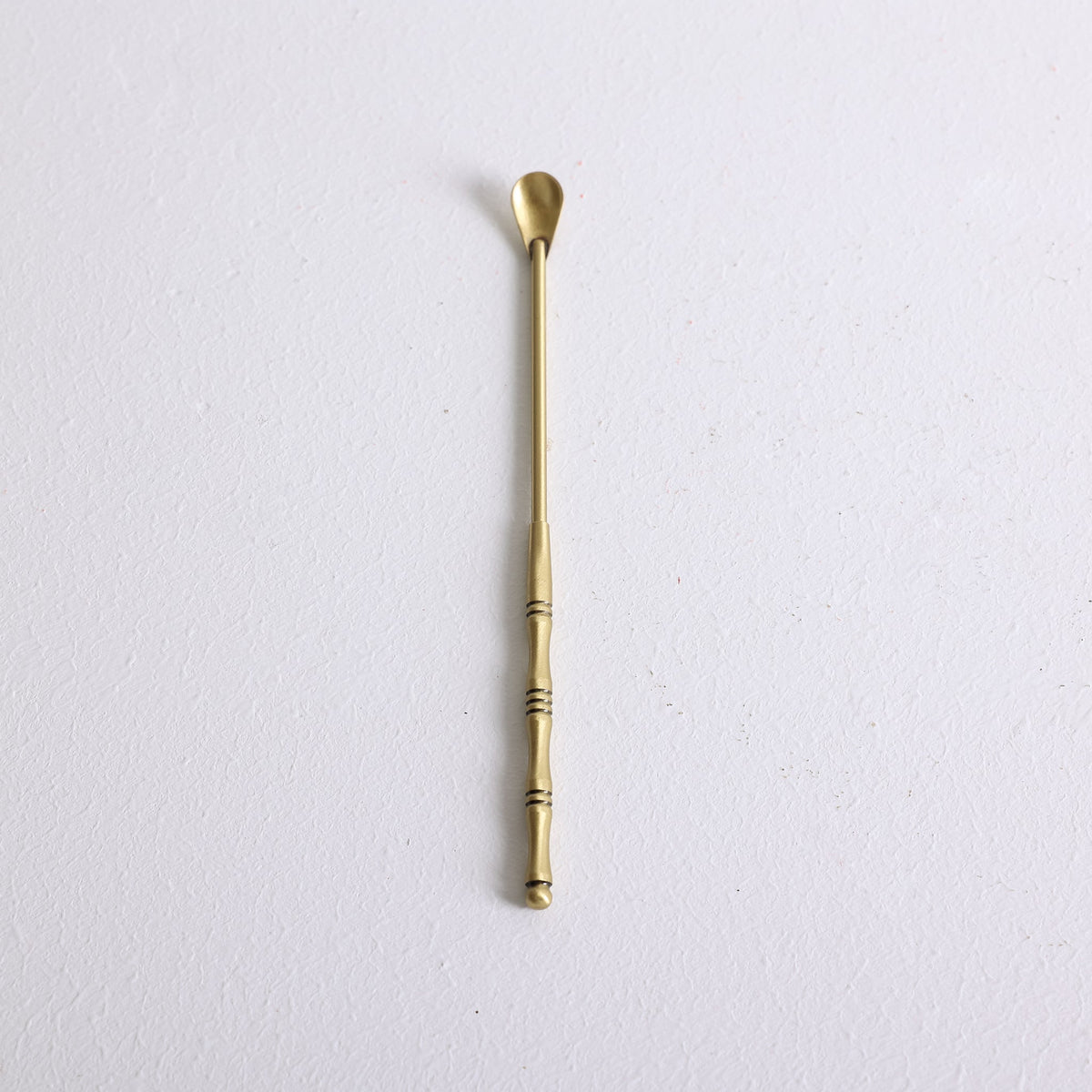 A small bronze spoon for scooping loose incense powder