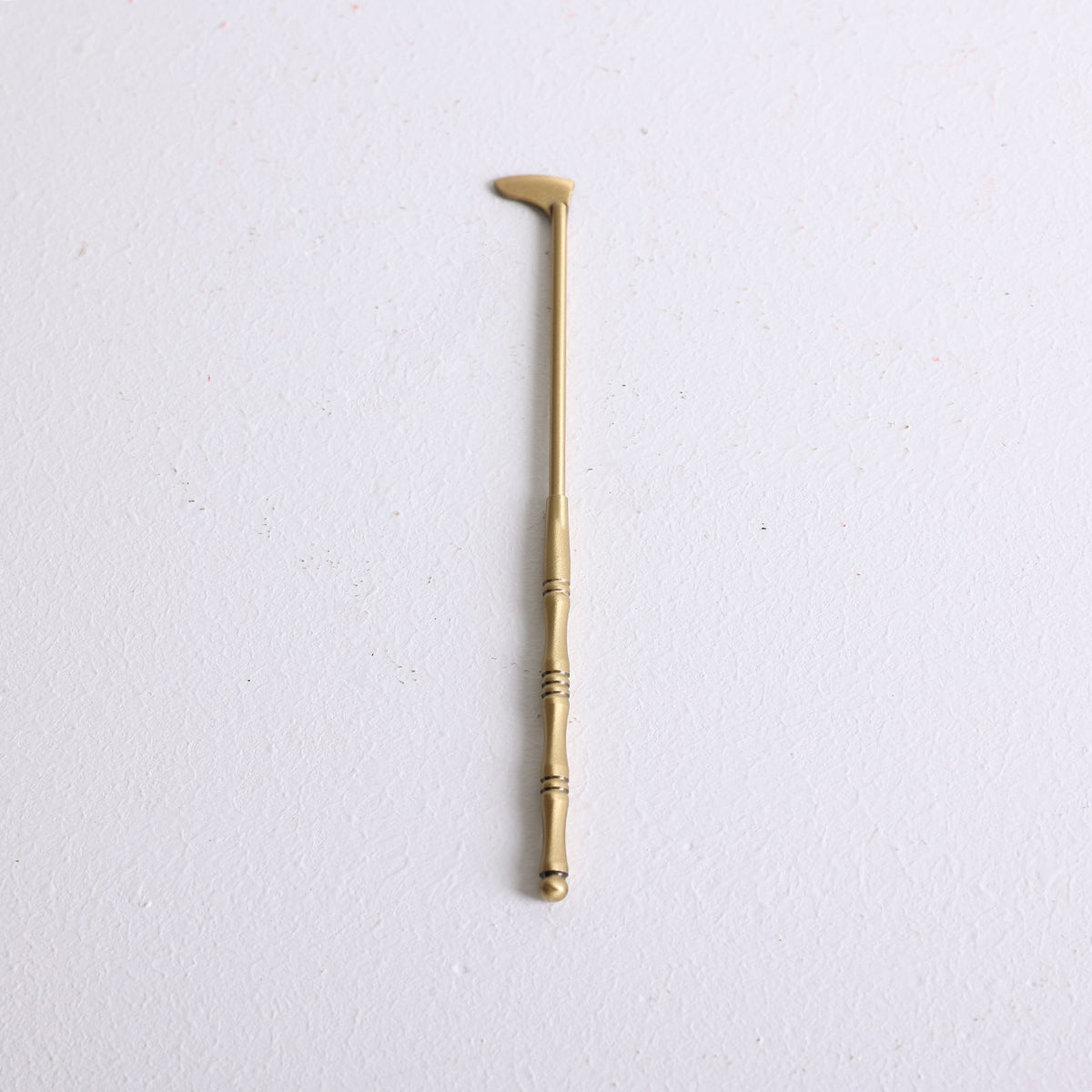 A small bronze spatula for distributing powder incense in a mold