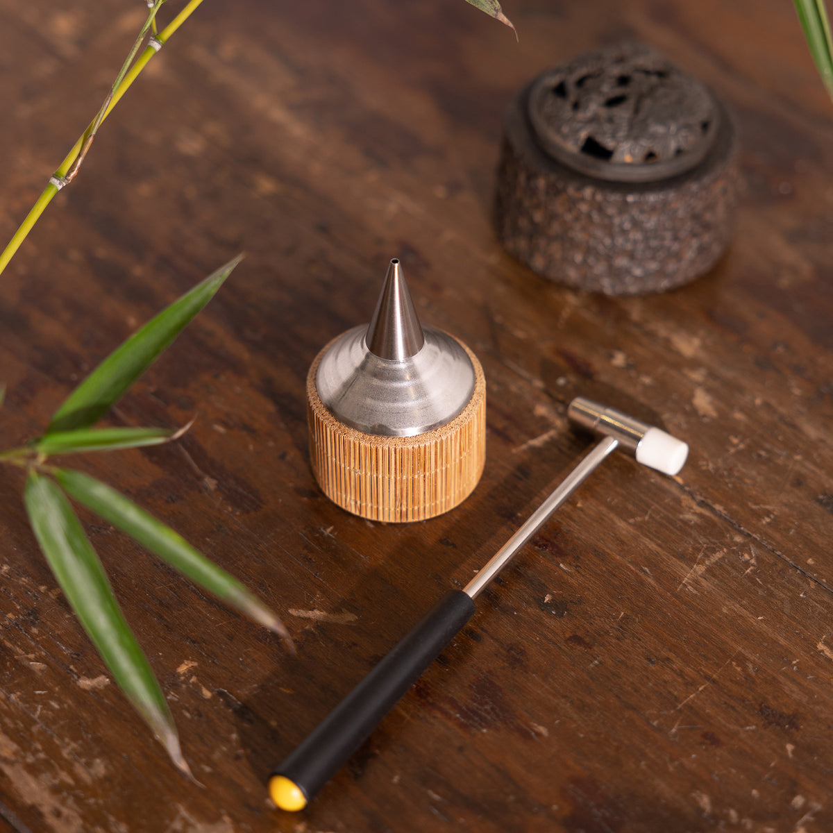 An angled view of Kin Object's incense powder burner and dropper set, showcasing their intricate design and high-quality materials