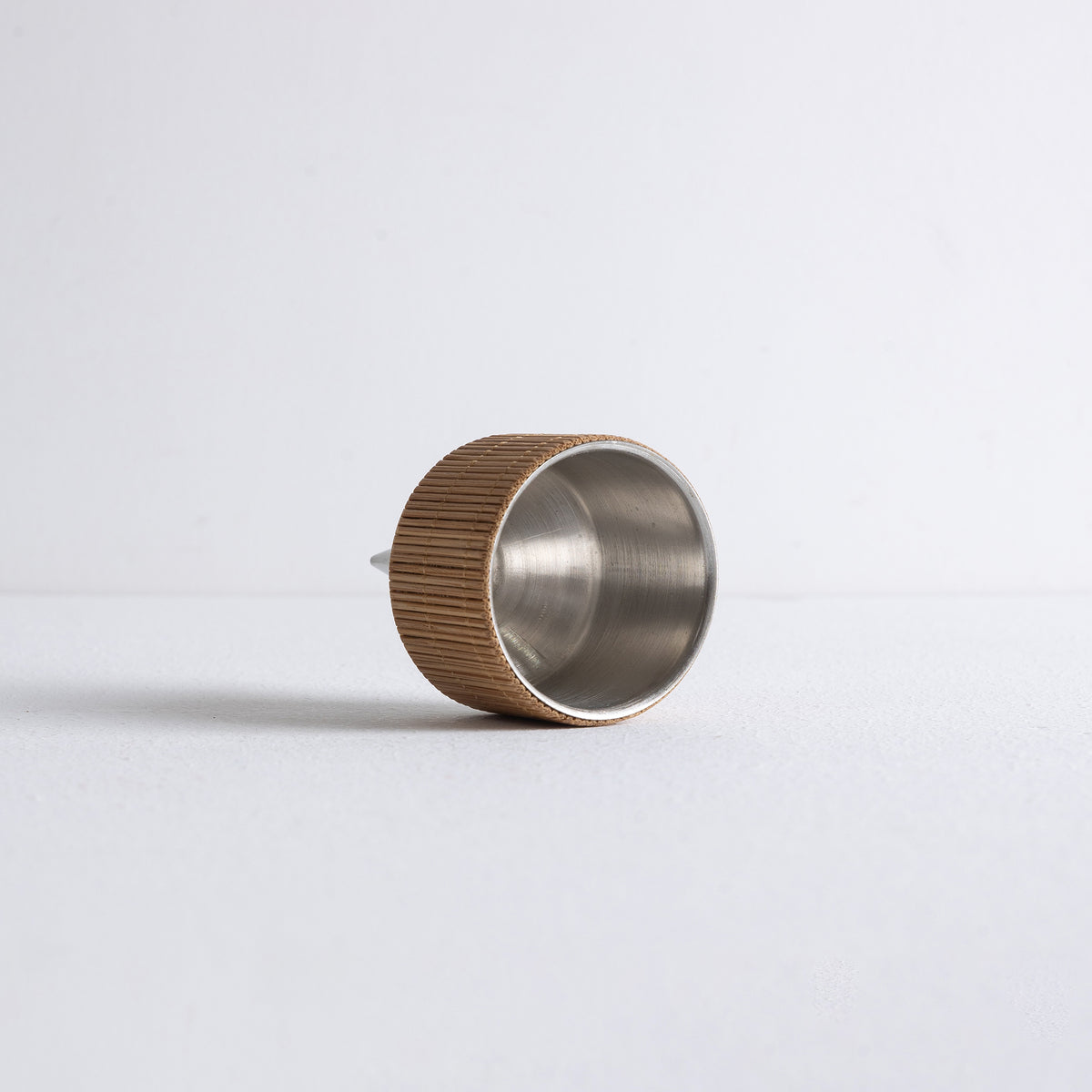 Angled view of Kin Object's incense powder dropper with bamboo details