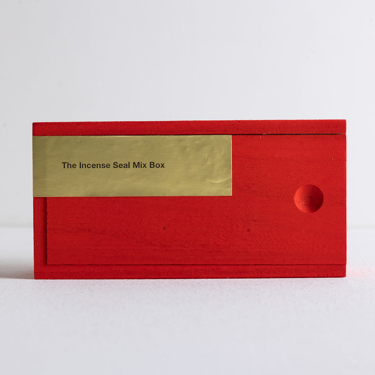 Red wooden box holding Kin Objects' 8 individually packaged incense seals