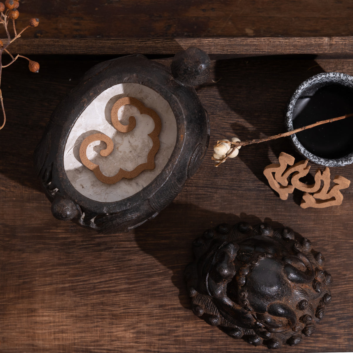Kin Object's ruyi-shaped ready-to-use incense seal, in an incense holder ready to burn