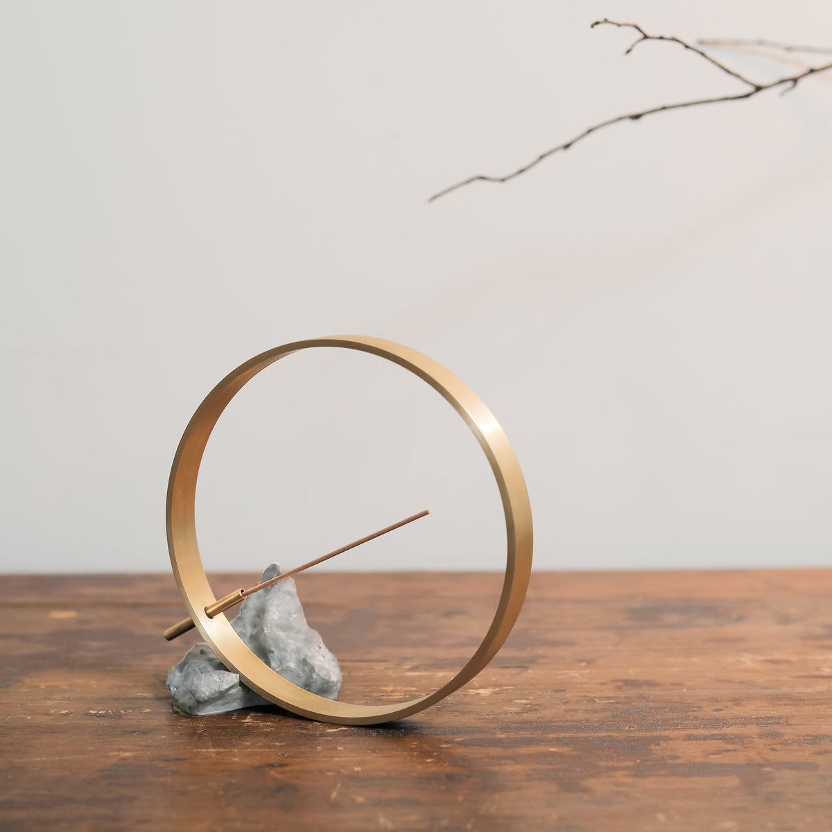 Modern Chinese brass incense holder on a wooden table