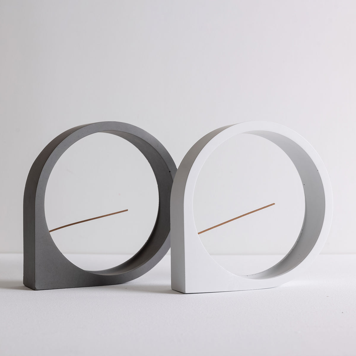 Dark gray and white concrete round incense burners together