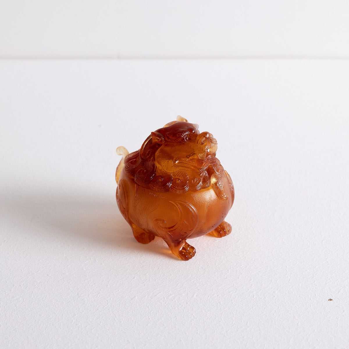 Top angled view of a liuli glass Suanni Lion incense powder burner