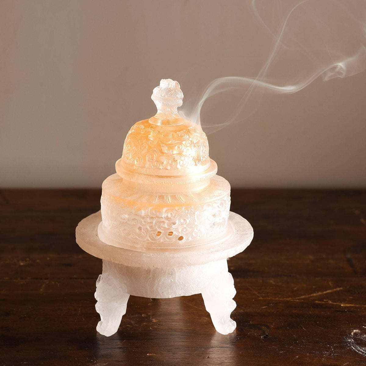 Incense powder burning in a traditional glass incense burner