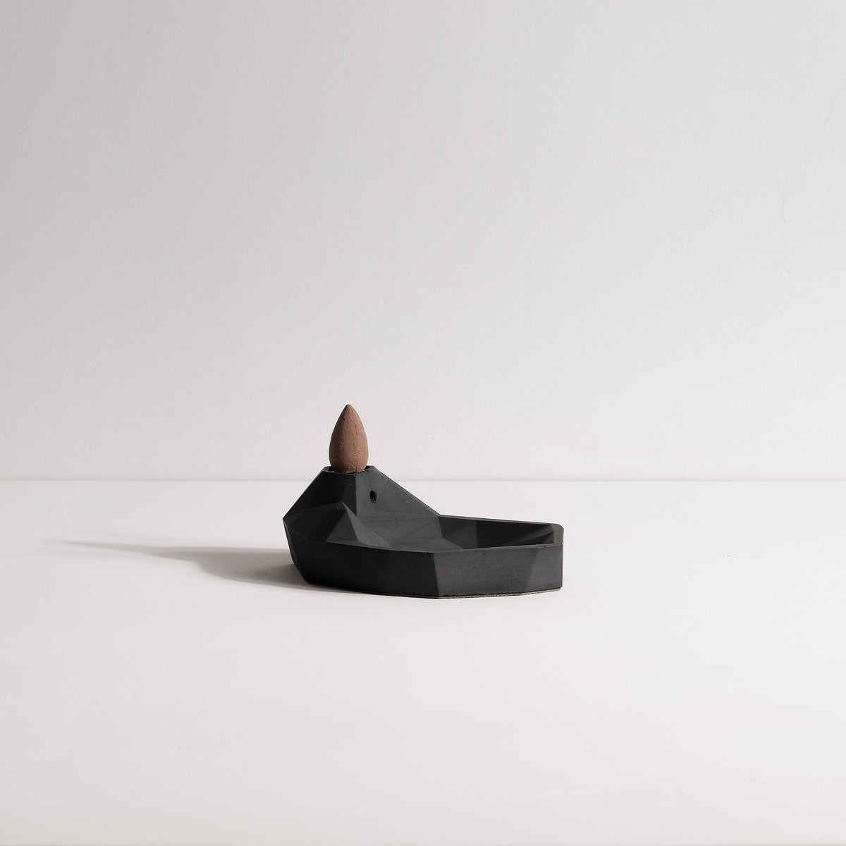 Side view of Minimal concrete Mountain & Lake incense fountain by Kin Objects