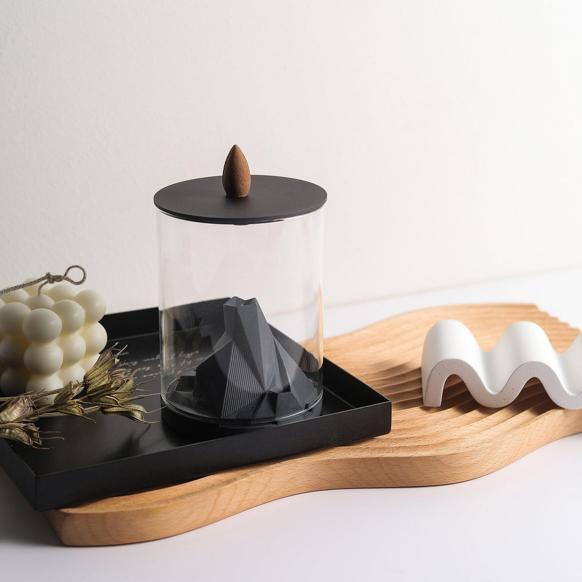 Caldera Terrarium Backflow Incense Burner by Kin Objects placed on table