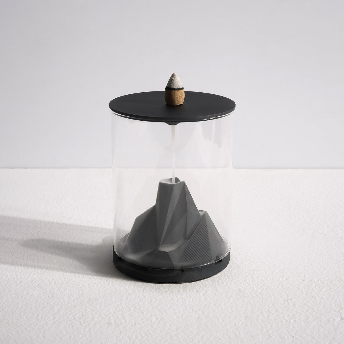 Smoke flowing down Caldera Terrarium Incense Waterfall by Kin Objects