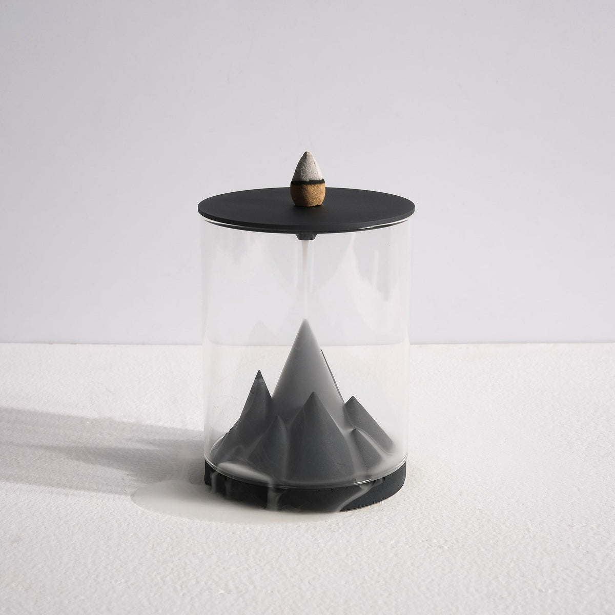 Karst Terrarium Backflow Incense Burner by Kin Objects with smoke flowing down