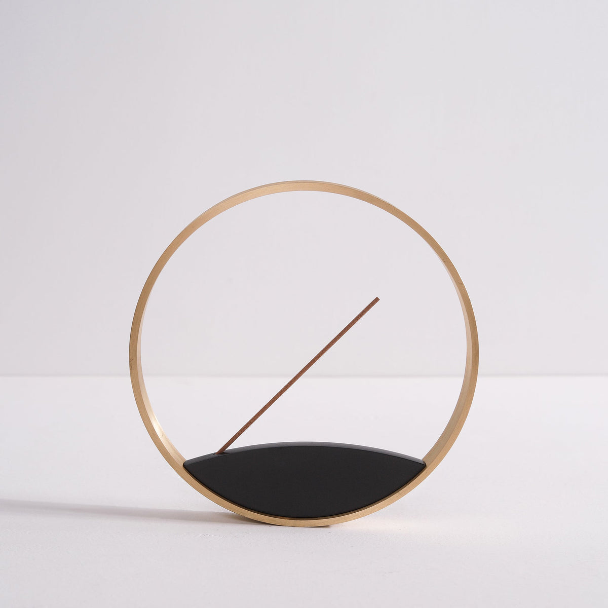 Front view of minimal bronze incense burner by Kin Objects