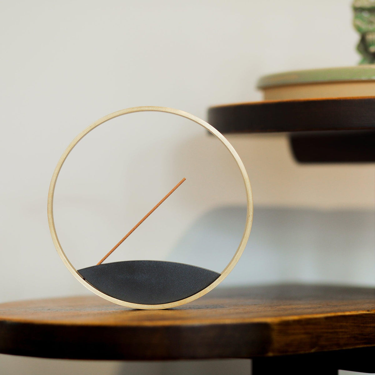 Front view of minimal bronze stick incense burner