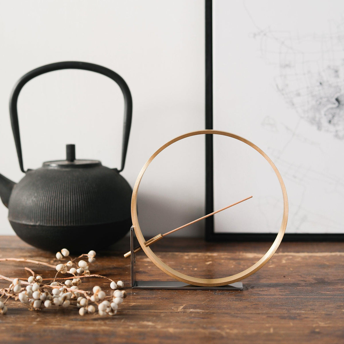 Bronze and brass modern incense holder on a table