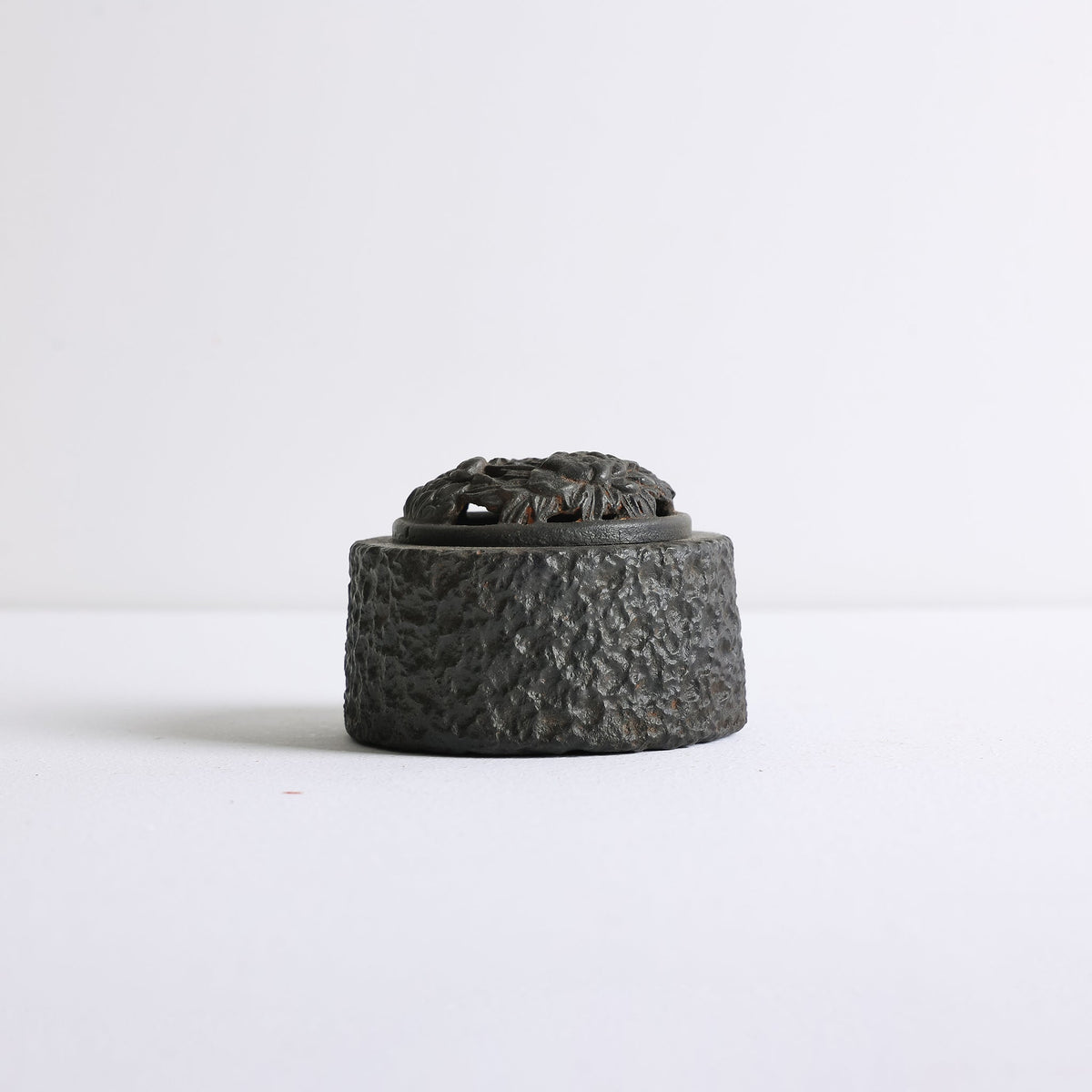 Side view of Earthen Peony Cast Iron incense burner by Kin Objects