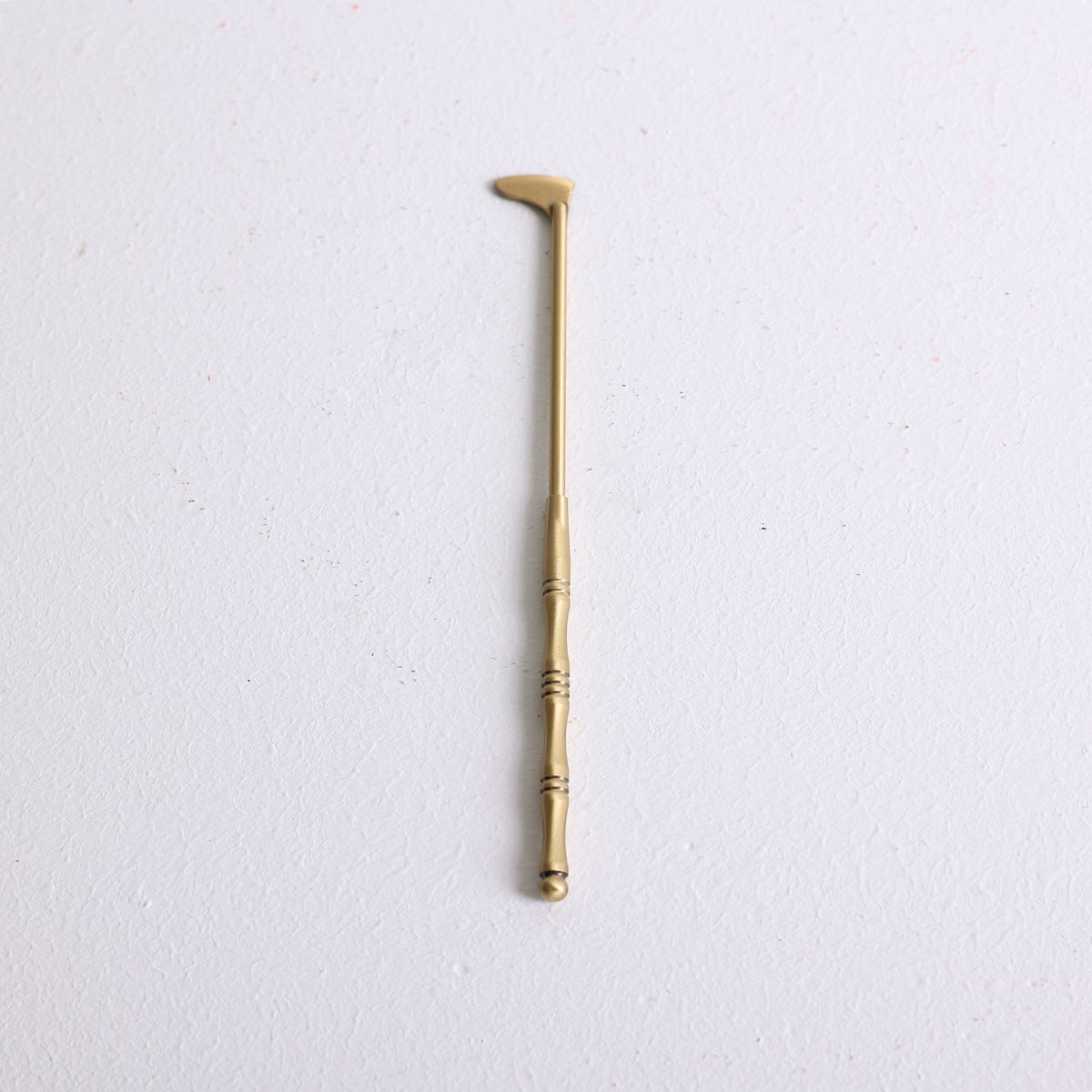 A small bronze spatula for distributing powder incense in a mold
