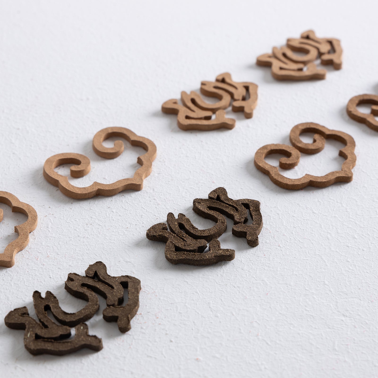 Set of incense seals featuring lotus flower and ruyi designs made from finely pressed incense powder, ready for use