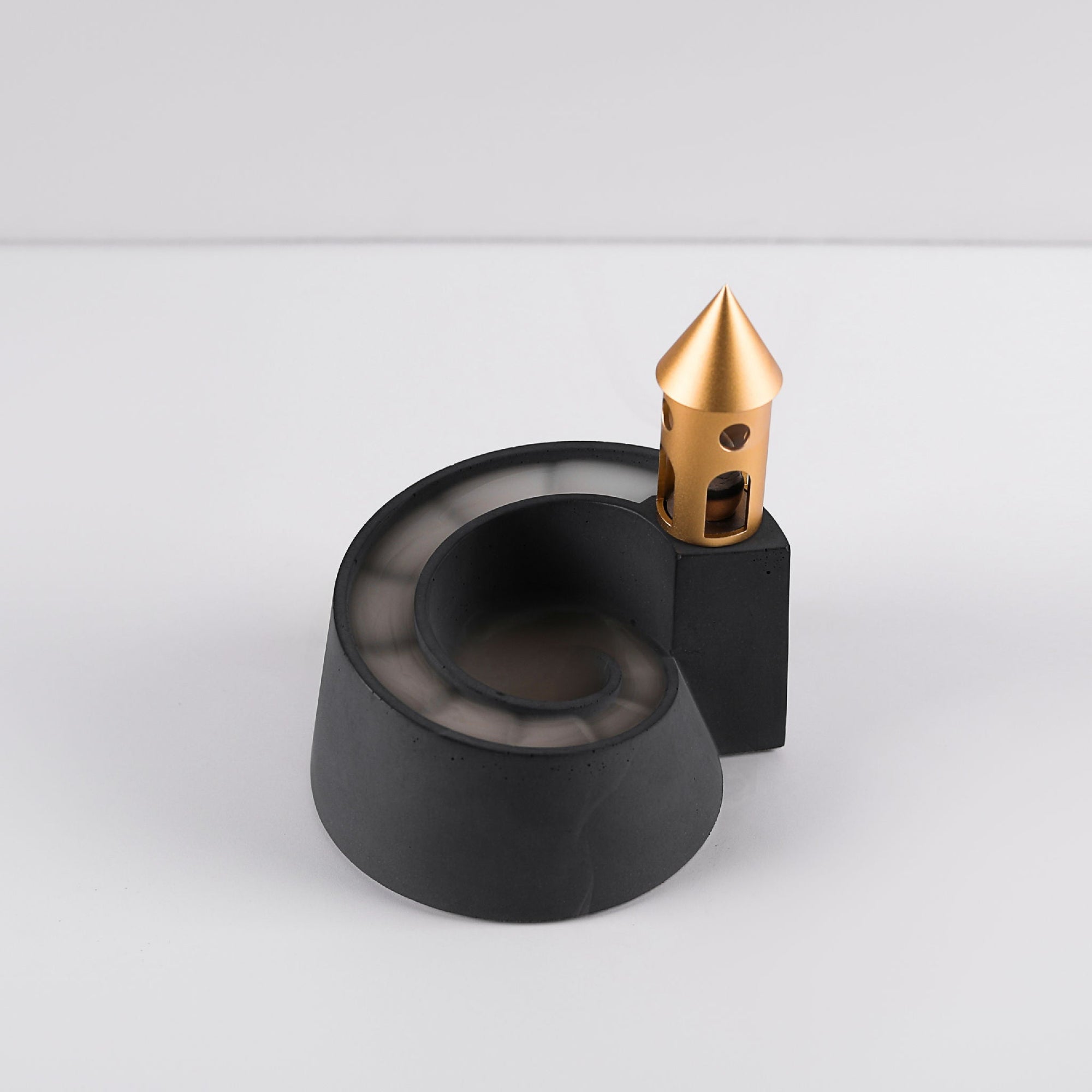 Cloud Nautilus Backflow Incense Burner by Kin Objects on a Table