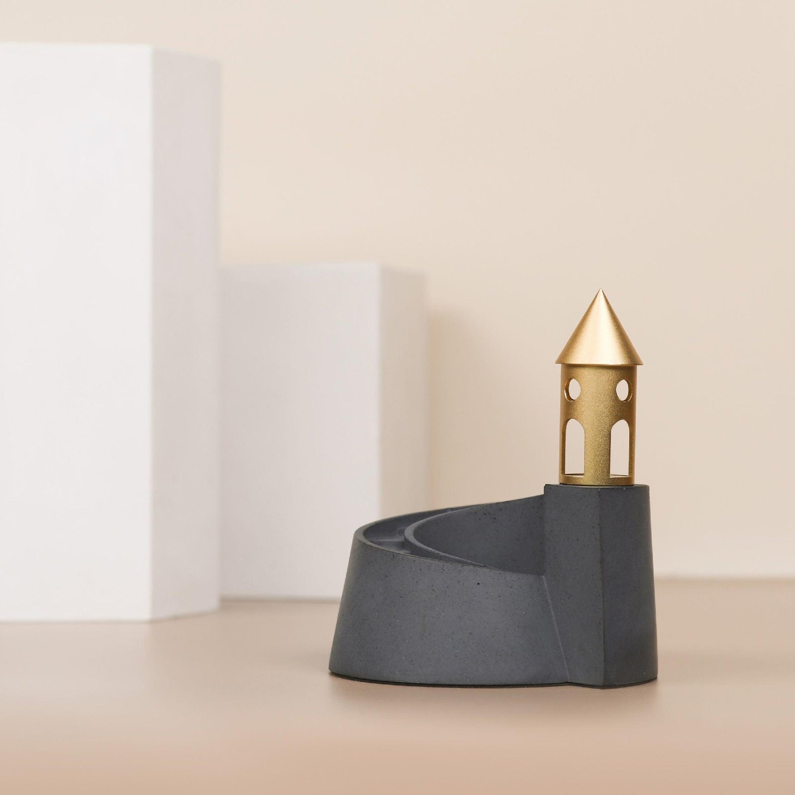 Cloud Nautilus Backflow Incense Burner by Kin Objects on a Table