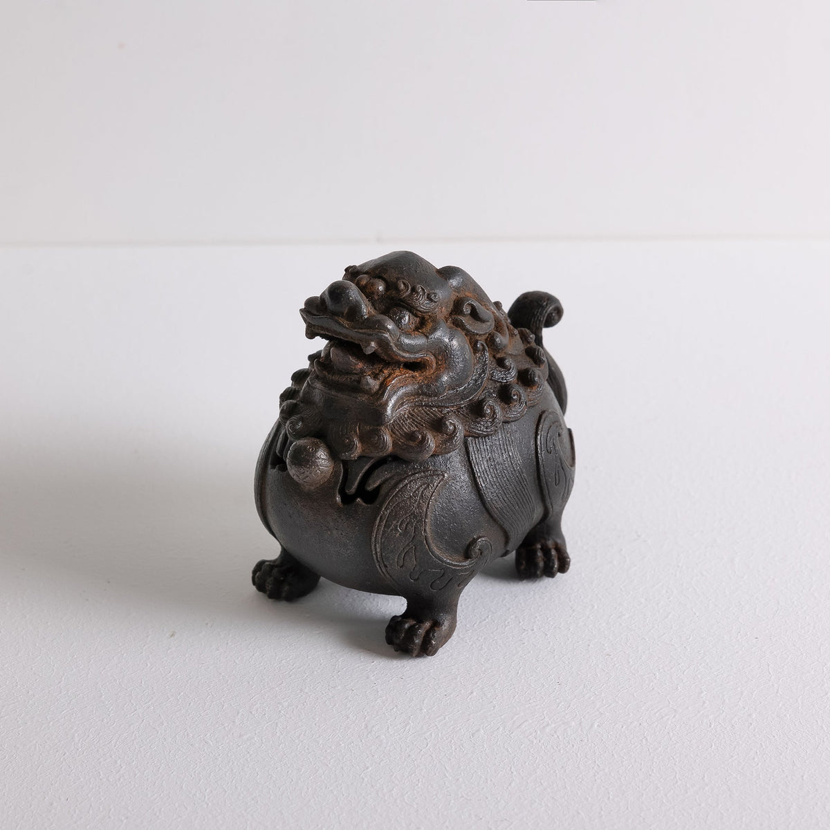 Top angled view of cast iron suanni lion incense burner for powder incense