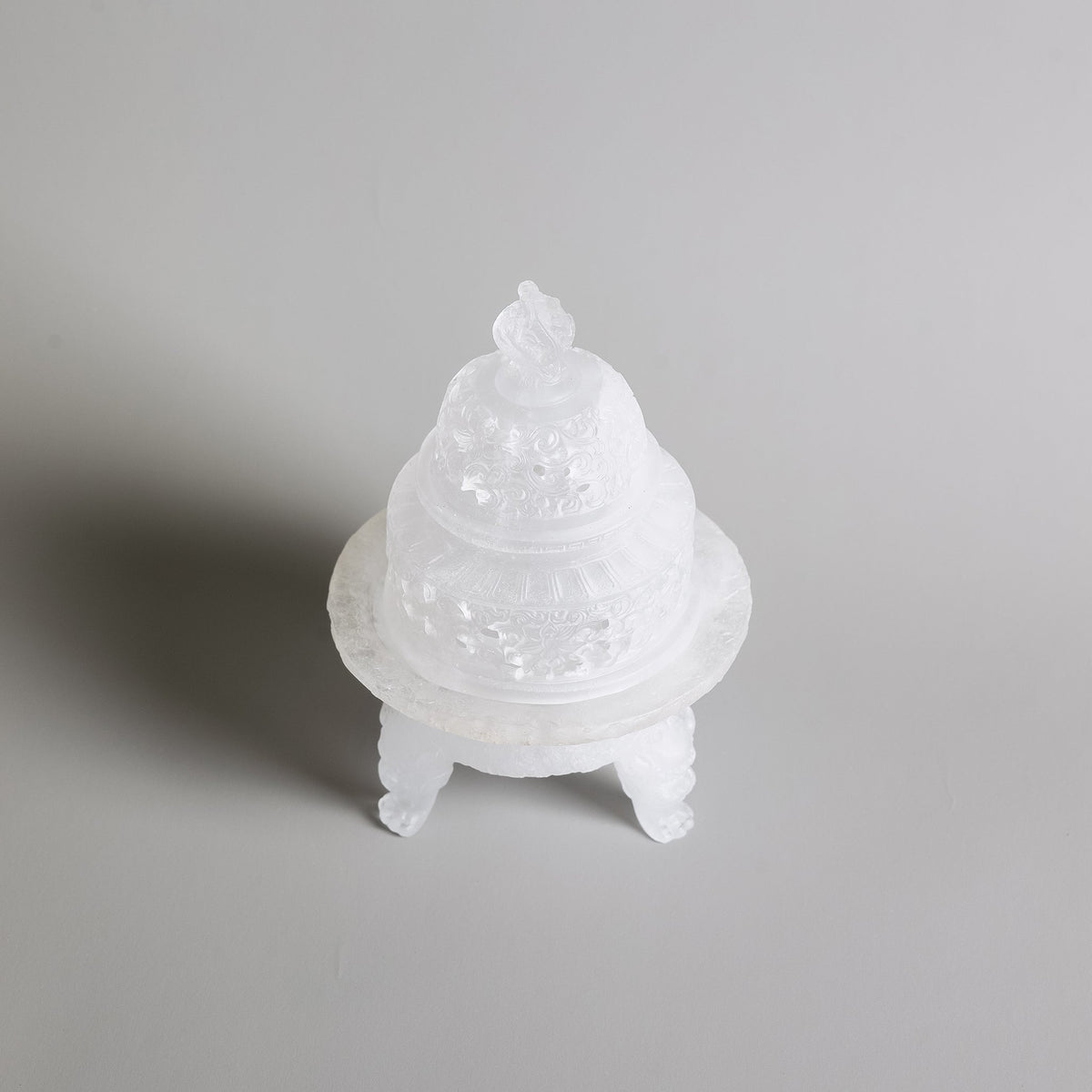 Top angled view of a tri-legged liuli cystal incense powder burner by Kin Objects