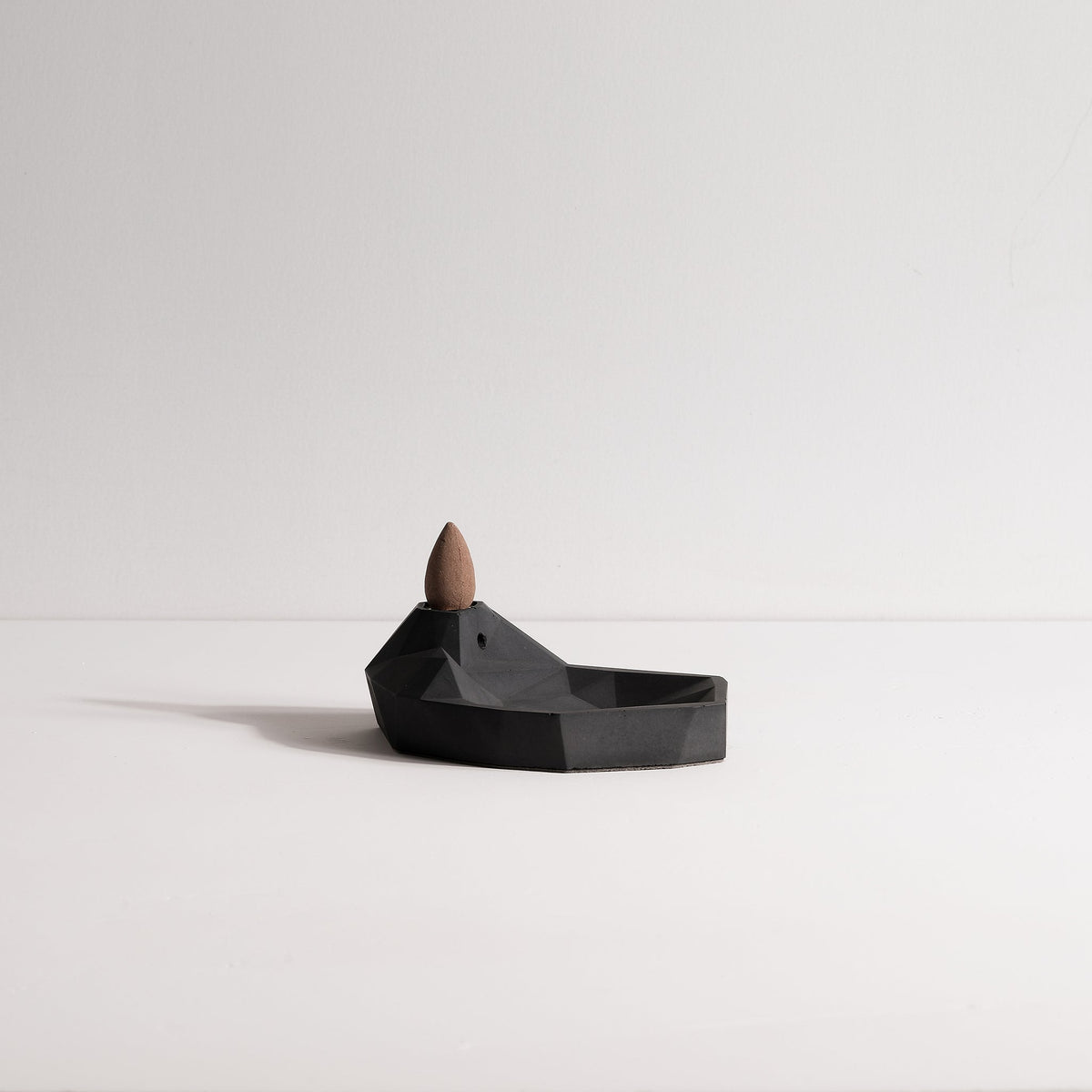 Side view of Minimal concrete Mountain &amp; Lake incense fountain by Kin Objects