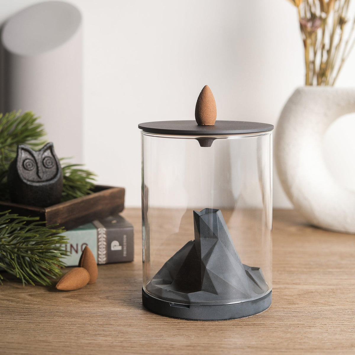 Caldera Terrarium Incense Fountain by Kin Objects on Table next to other Decor