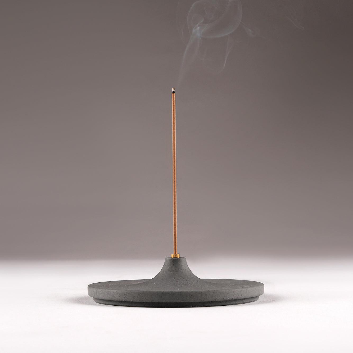 Minimal Incense Holder Disk with a burning incense and smoke flowing