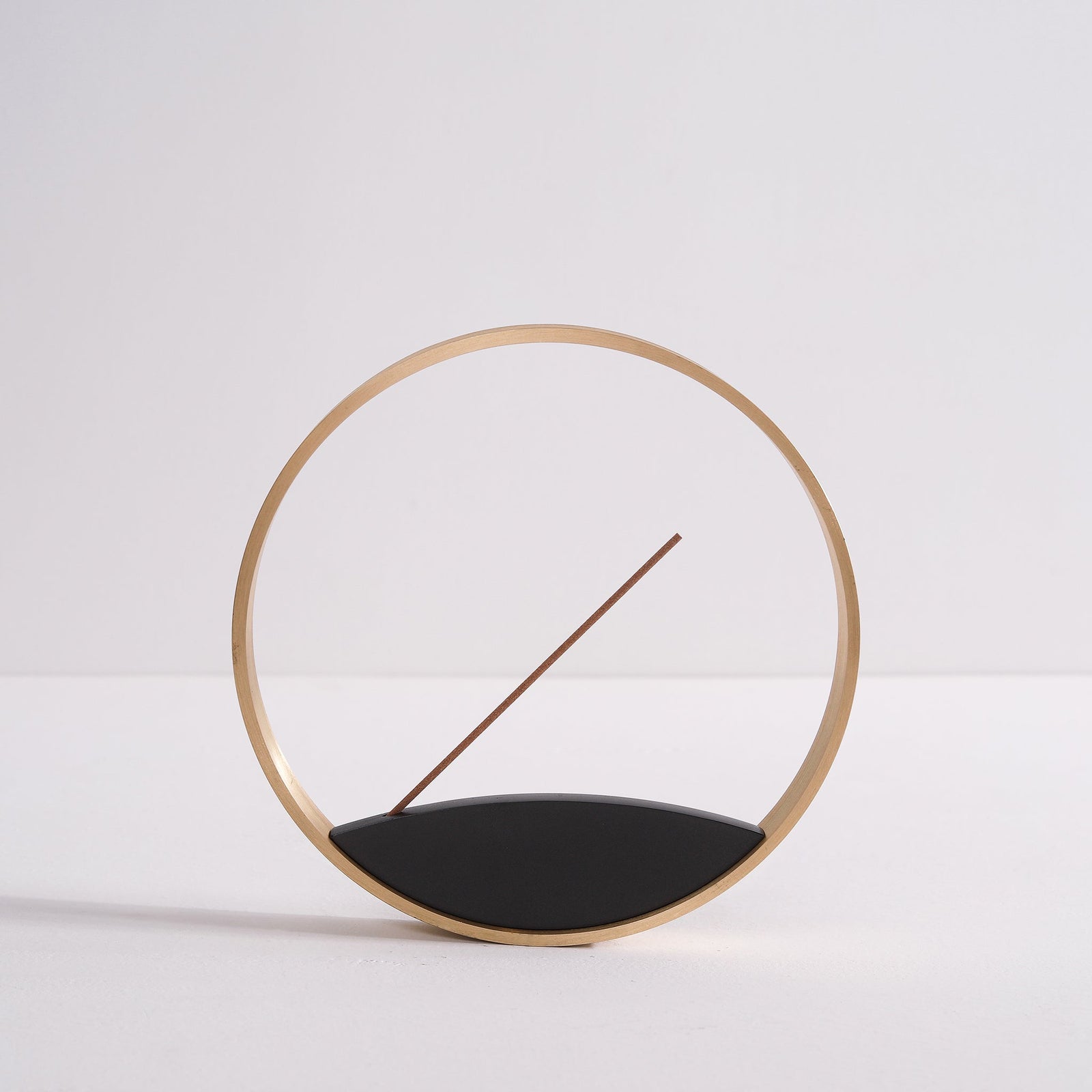 Moon Horizon bronze incense burner on a window sill