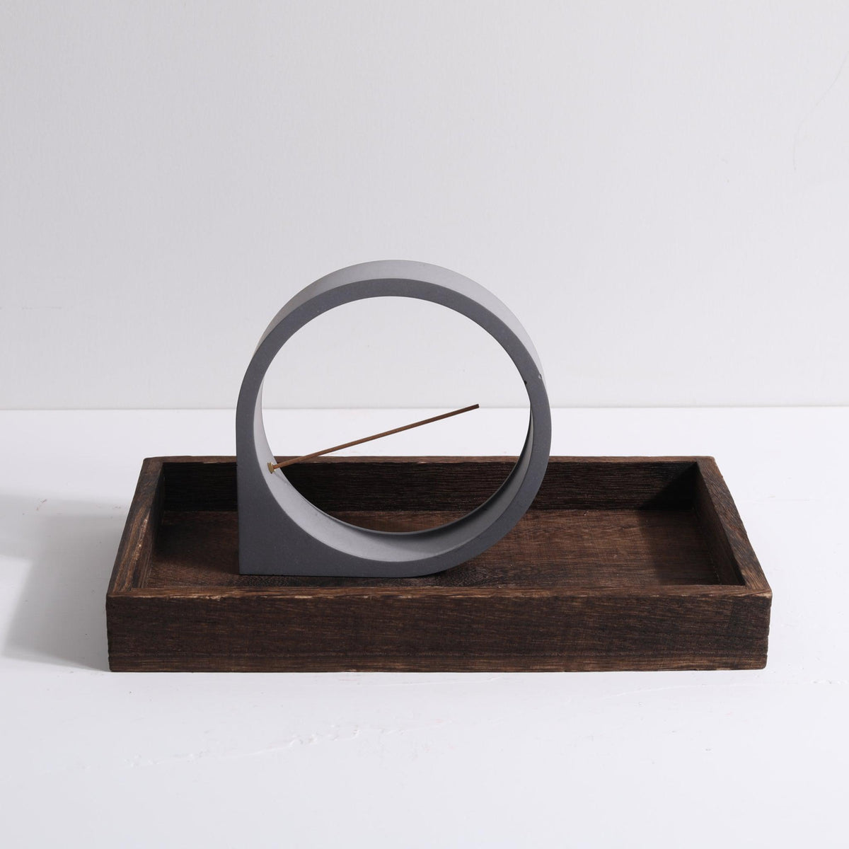 Front view of smaller Moon incense holder by Kin Objects on wooden tray