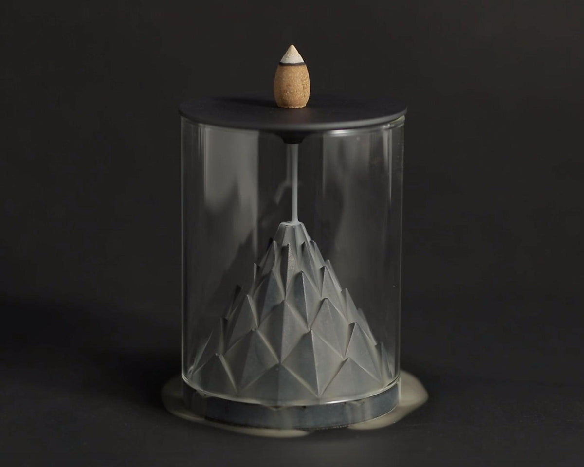 Incense flowing down a modern minimal incense burner by Kin Objects